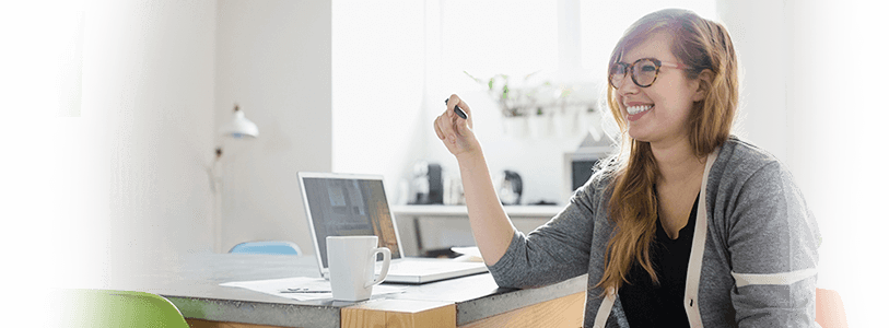 Smiling woman sitting in front of her computer at work